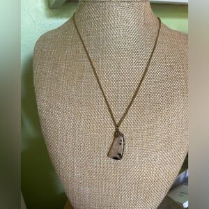 Gold necklace with unique stone pendant